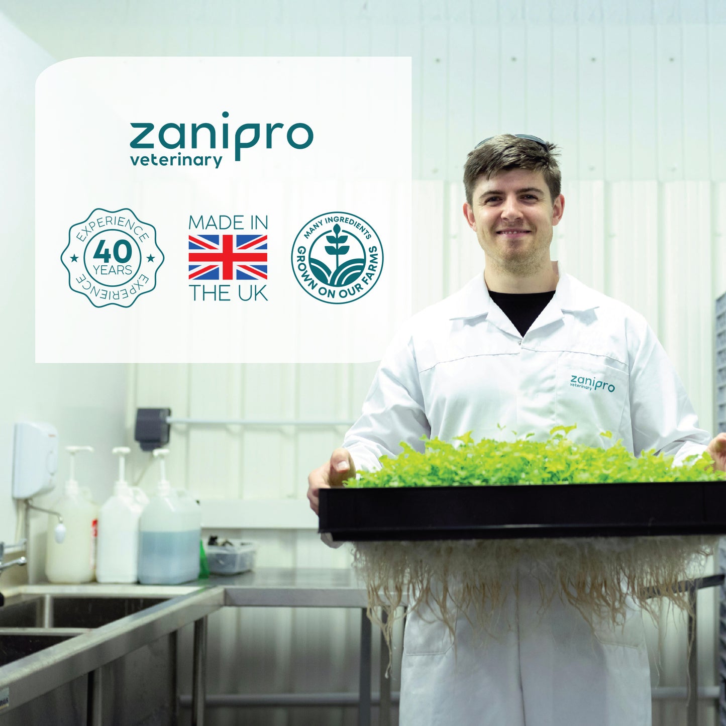 Person in a lab holding a tray of herbs with Zanipro branding in the background.